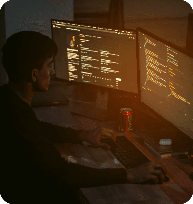 Cybersecurity - Person in front of a dual screen